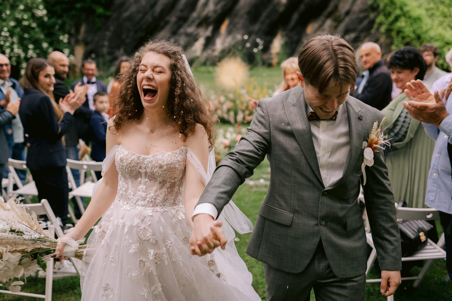 Couple walking away from their tenerife intimate wedding ceremony under confetti and laughing
