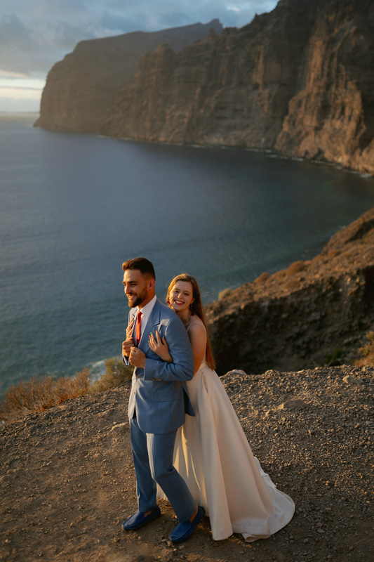 Bride and Groom embrace in front of Los Gigantes after their wedding ceremony in Tenerife